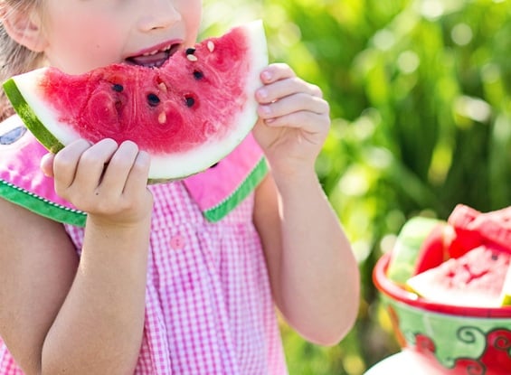 Little girl eating a watermelon