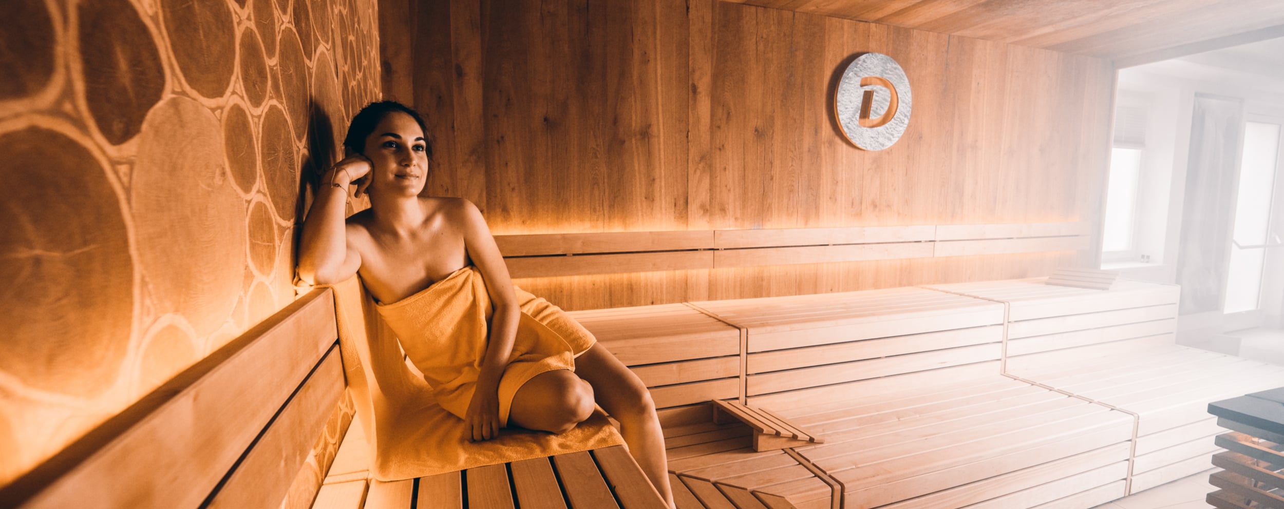 Woman with towel in the sauna at the Day Spa in Hotel Dilly