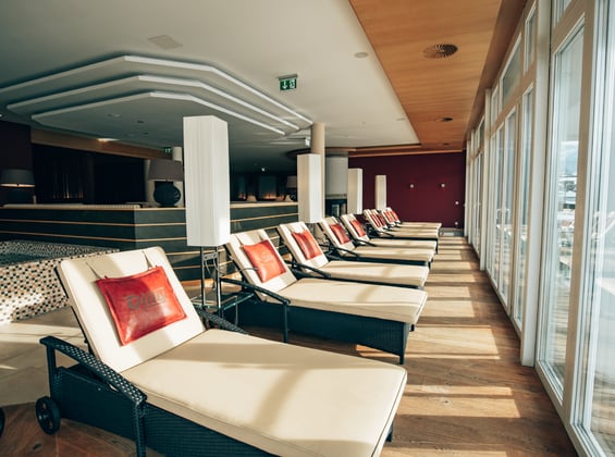 Cushioned loungers in front of a window front