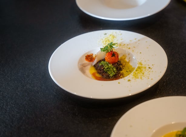 Salad on a black plate in the hotel restaurant in Windischgarsten